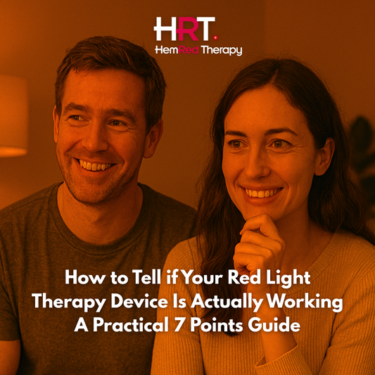 A man and woman sitting side by side in a dimly lit, modern room, softly illuminated by red light. Both have mildly amused, thoughtful expressions as they gaze off-camera, suggesting curiosity and light skepticism during a wellness session